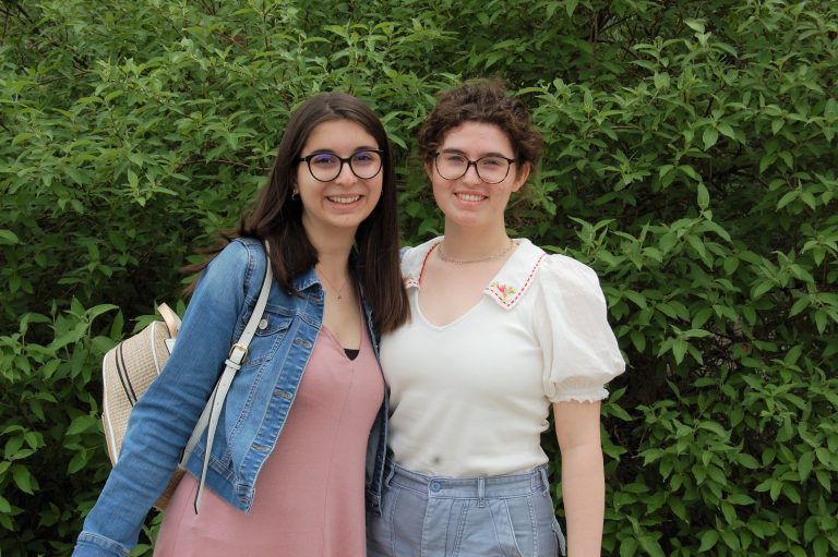 Two students smiling.